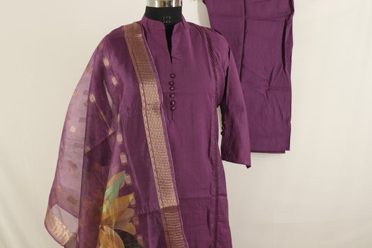 Purple traditional outfit with a floral shawl on a mannequin against a plain background